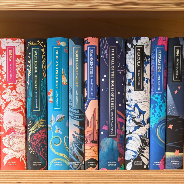Row of vintage books with colorful covers on a wooden shelf